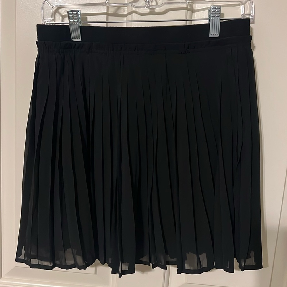 Black pleated sheer skirt. Lined so it is solid black. Knit waist band.